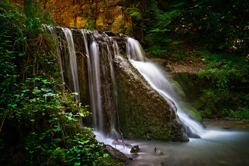 Waterfall in the green forest in Poland.
