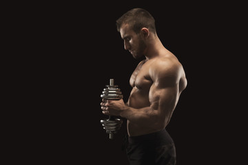 Strong man with dumbbell showing muscular body