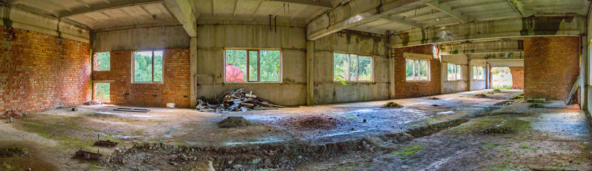 empty deserted room of an abandoned building in the middle of a wide, dense forest