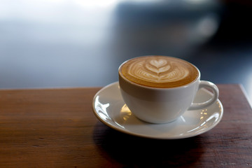 close up a coffee cup on wooden table.
