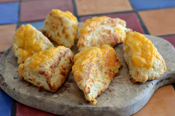 Homemade Cheese Biscuits (scones) served on a wooden board.