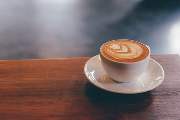 close up a coffee cup on wooden table.