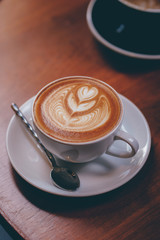 close up a coffee cup on wooden table.