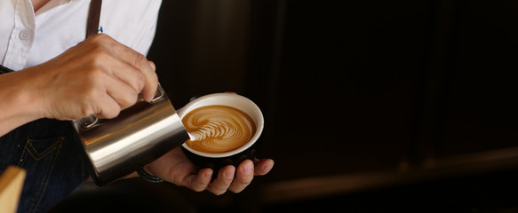 Branner of barista hand making a cup of coffee. - obrazy, fototapety, plakaty