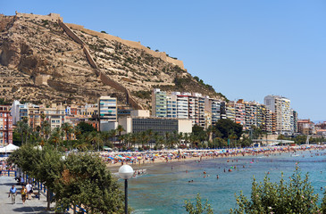 Obraz premium Tourists sunbathing on a Postiguet Beach of Alicante city. Spain
