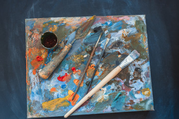 artists brushes and oil paints on palette.