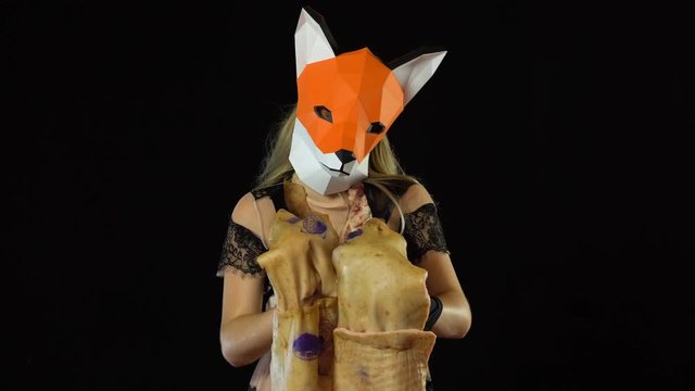 Blonde Girl with Fox Mask paper Using Pig Skin for Covering. Black Background. 4k UHD