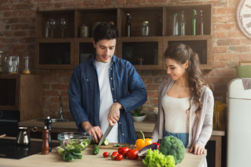 Happy couple cooking healthy food together