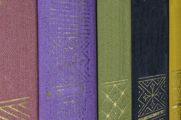 a stack of colorful books on the shelf