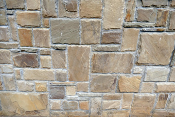 A wall lined with natural stone.