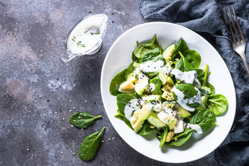 Green salad with avocado, spinach egg and cucumber.