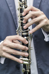 Close-up of fingers on a clarinet. 