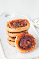 Fried savoury cottage cheese pies with minced meat on white plate, served with yogurt, vertical, copy space