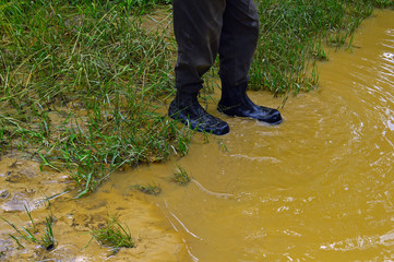A man in rubber boots