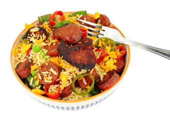Bowl of egg fried rice with spicy chorizo salami and Chilli peppers background