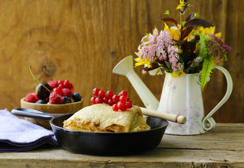 thin pancakes stack in a frying pan, rustic still life