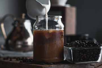 coffee In a glass bottle,Coffee drip,Hand holding a kettle Drip Coffee In the room,Black coffee in glass