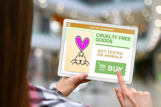 Cruelty free concept, girl holds the digital tablet on blurred mall background