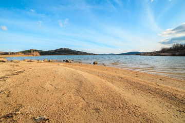 Beautiful lake in the mountains at sunset on a sunny day with blue sky  