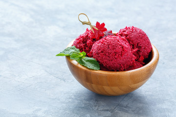 Artisanal beetroot ice cream in a wooden bowl.