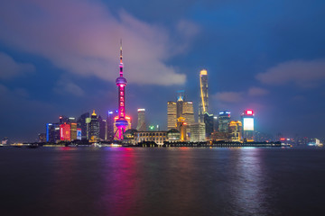 Shanghai city skyline Pudong side looking through Huangpu river on twilight time. Shanghai, China. Beautiful vibrant panoramic image.