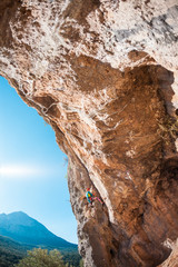 The girl climbs the rock.