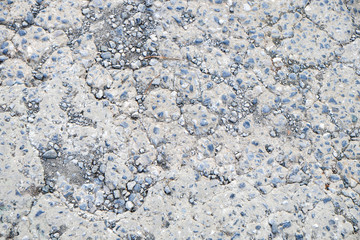 Cracked concrete with small rock textured background