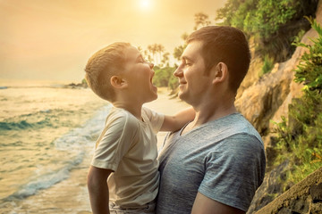 Fototapeta premium Happiness Father and son stay on the sea coastline. Tropical beach