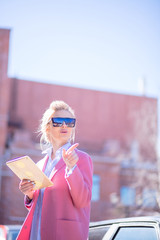 Woman using tablet internet in the street Young tourist looking for direction online during...