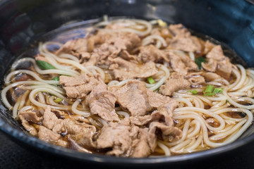 fresh beef noodle in black bowl
