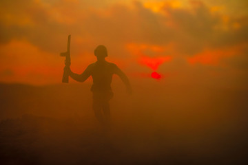 War Concept. Military silhouettes fighting scene on war fog sky background, World War Soldiers Silhouettes Below Cloudy Skyline at sunset. Attack scene. Armored vehicles. German tank in action