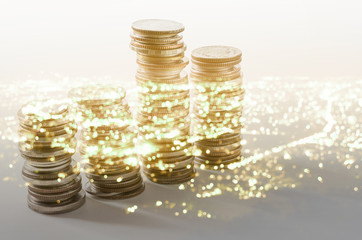 dobule exposure of coins stack and abstract bokeh of old night modern city building for business background