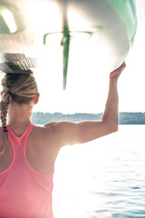 young sexy woman girl family are doing yoga on an sup board at a lake sea water