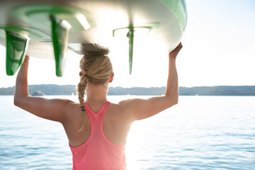 young sexy woman girl family are doing yoga on an sup board at a lake sea water
