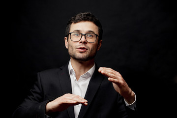 young ambitious man is explaining how to move upwards in the jobs. secret of happy life.close up portrait