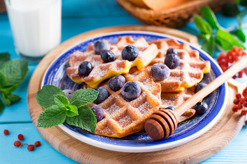 Sweet Homemade Pumpkin Waffles with sugar powder and berries