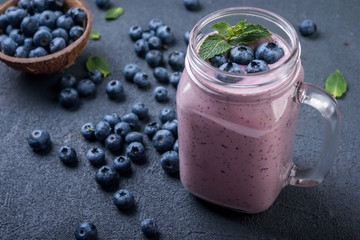 smoothie or shake with fresh blueberries and mint on a dark  background - Powered by Adobe