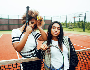 young pretty girlfriends hanging on tennis court, fashion stylis