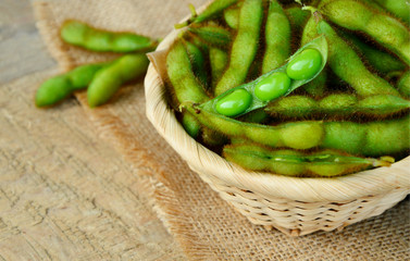 boiled Edamame bean or young green soybean in basket on wooden floor.
Surprising Health Benefits of Edamame.