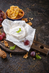 Cheese with honey, nuts and grapes