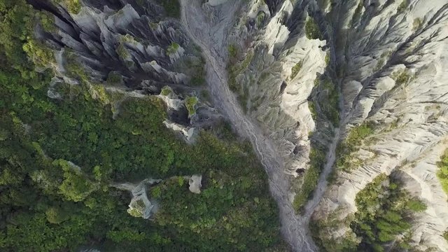 Top down aerial Putangirua Pinnacles and river, New Zealand popular hiking and film location.