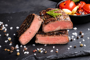 Close-up of steak Top Blade roasting medium ready to eat on dark stone background