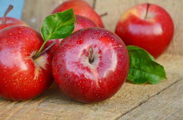 Fresh Gala apples or red apples with leaf and water drop with wooden background.