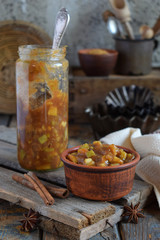 Homemade Apple Jam with Cinnamon. Pieces of apples in caramel syrup for baking pie. Autumn canning and preserving. Conservation of harvest. Organic healthy vegetarian food. Rustic style.