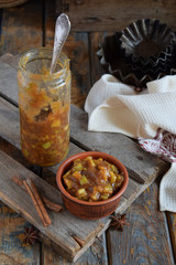 Homemade Apple Jam with Cinnamon. Pieces of apples in caramel syrup for baking pie. Autumn canning and preserving. Conservation of harvest. Organic healthy vegetarian food. Rustic style.