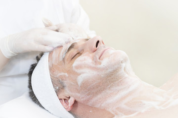 Man in the mask cosmetic procedure in spa salon 