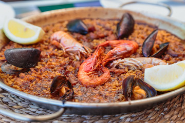 paella in Spanish with seafood and rice in a pan
