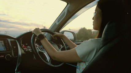 Woman drive a modern car on the road.