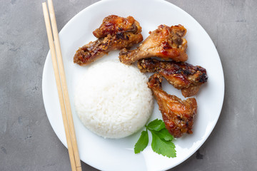 Teriyaki chicken with rice on gray background. Top view.