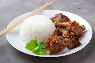 Teriyaki chicken with rice on gray background